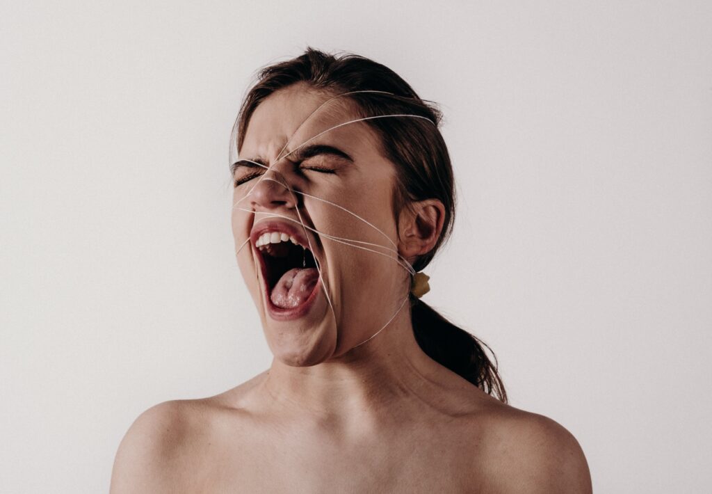 Woman yelling while wrapped in twine
