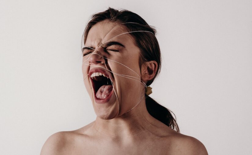 Woman yelling while wrapped in twine